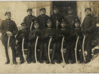 Józef Lewandowski wśród kolegów z oddziału – lata 20-te XX wieku, żołnierze w mundurach i czapkach rogatywkach w dwóch rzędach stoją i siedzą trzymają ręce na szablach opartych pionowo o ziemię